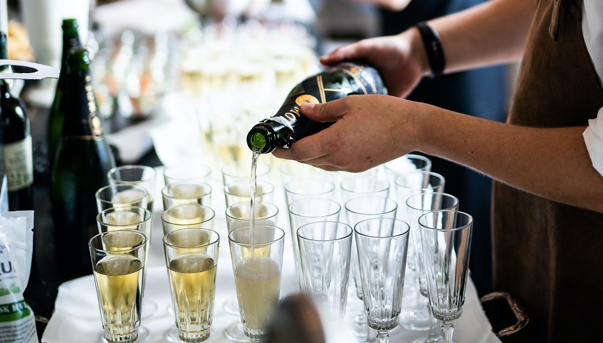 Champagne is poured into glasses.